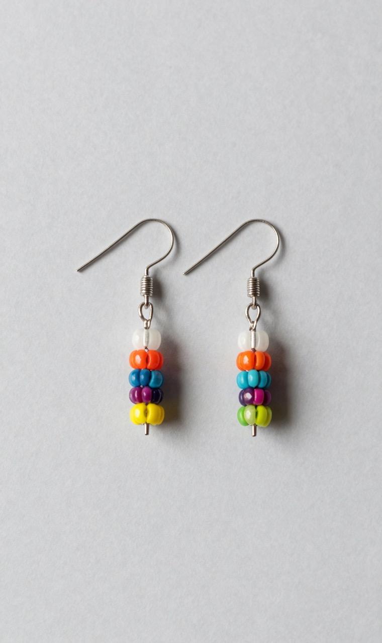 A pair of fuse bead earrings on a display stand