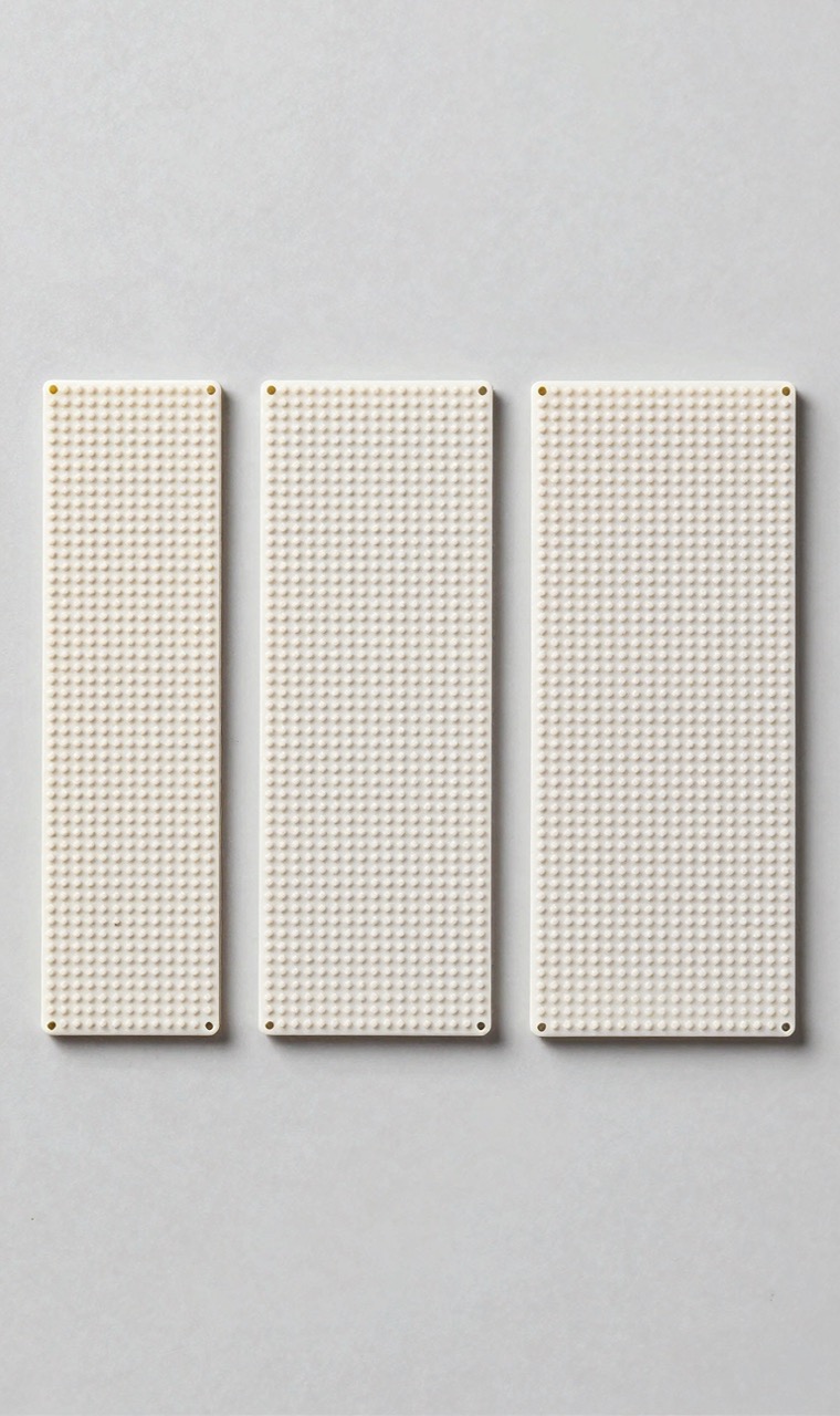 Three empty plastic pegboards of different sizes side by side